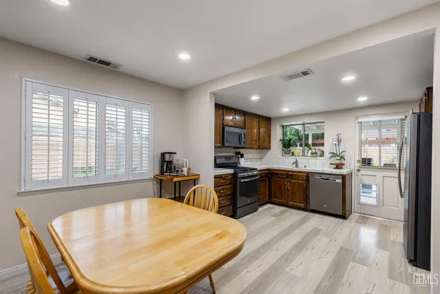 a kitchen with stainless steel appliances granite countertop a refrigerator and a sink
