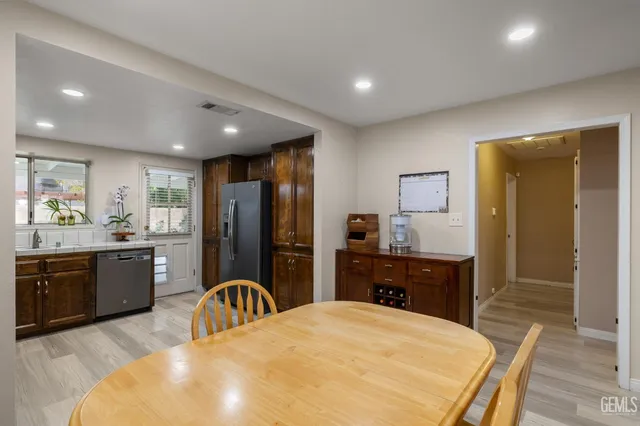 a kitchen with stainless steel appliances granite countertop wooden cabinets and a stove top oven