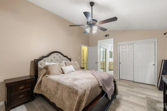 a bedroom with a large bed and a chandelier