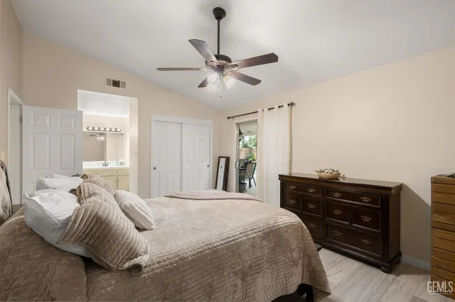 a bedroom with a bed and a ceiling fan