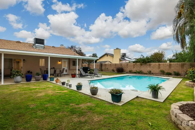 an aerial view of residential houses with outdoor space and parking
