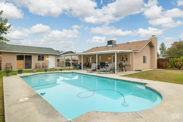 an aerial view of a house with a swimming pool