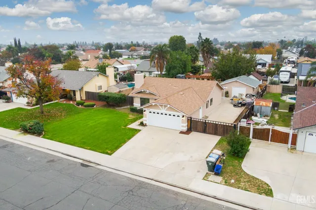 an aerial view of a house with a garden and trees