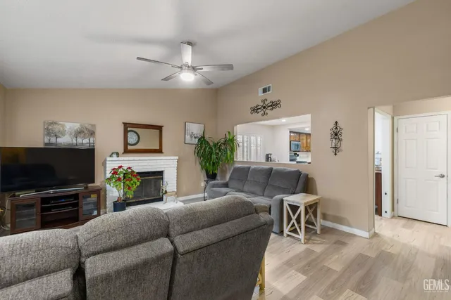 a living room with furniture a flat screen tv and a fireplace