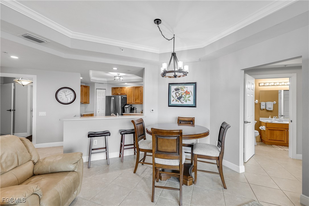 2743 First Street, Unit 1502 Fort Myers, FL 33916 - Photo 11 of 35 a living room with furniture and a chandelier