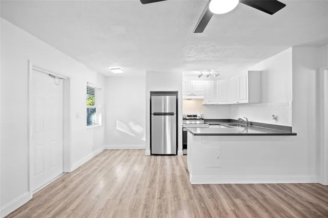 a kitchen with stainless steel appliances granite countertop a stove and a refrigerator