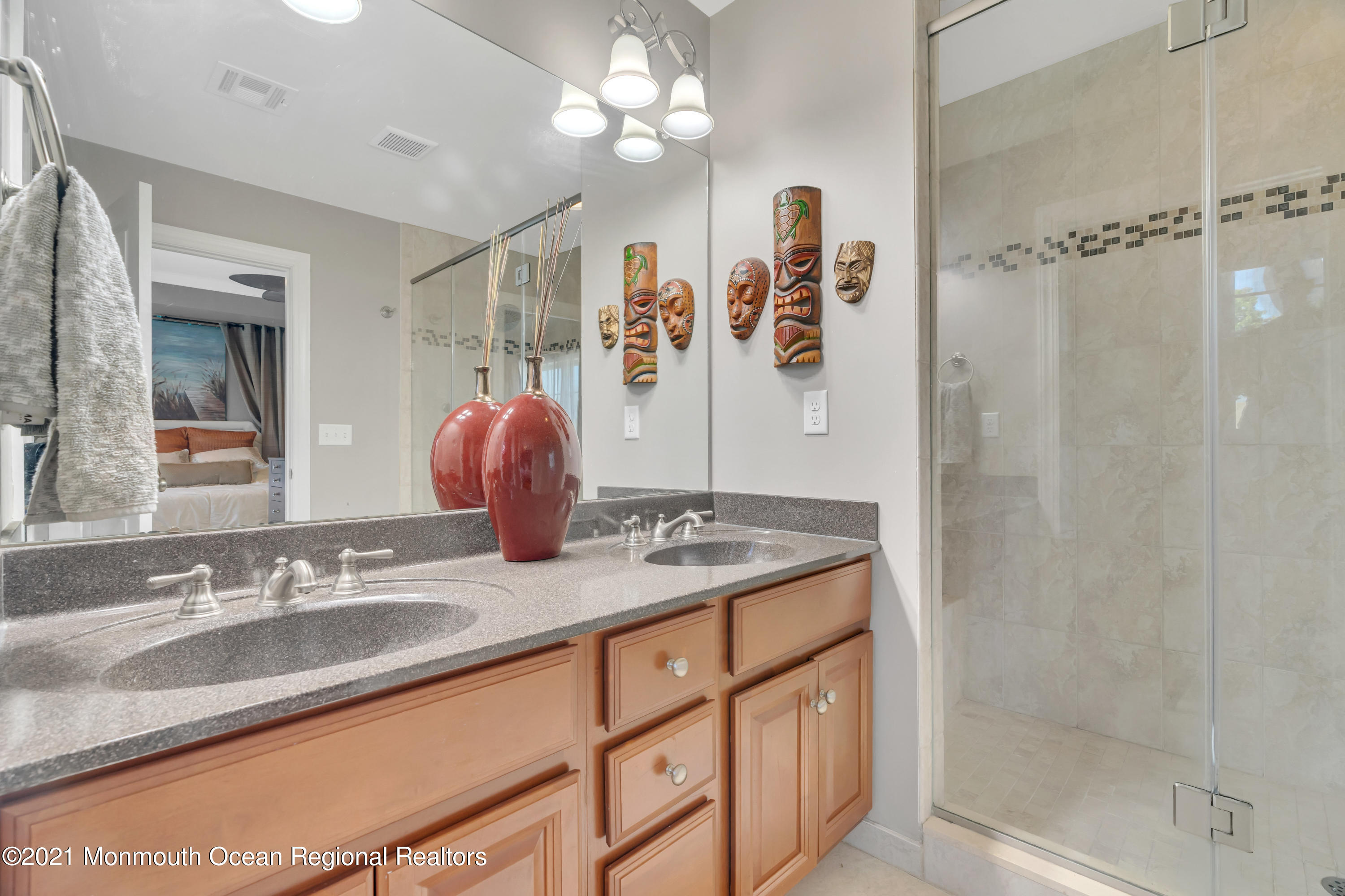 3809 River Road Point Pleasant, NJ 08742 - Photo 22 of 66 a bathroom with a granite countertop sink a mirror and shower