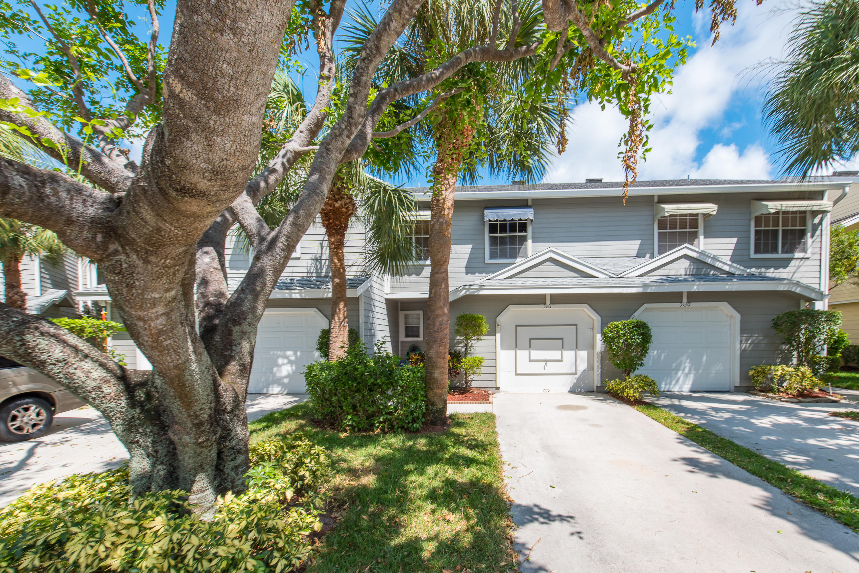 5116 Pointe Emerald Lane, Unit 5116 Boca Raton, FL 33486 - Photo 14 of 23 front view of a house with a yard