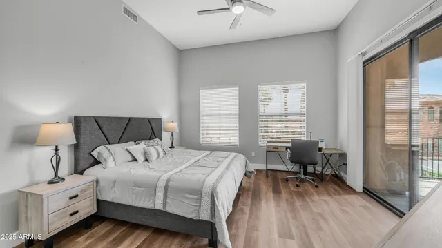 a bedroom with a bed and a large window