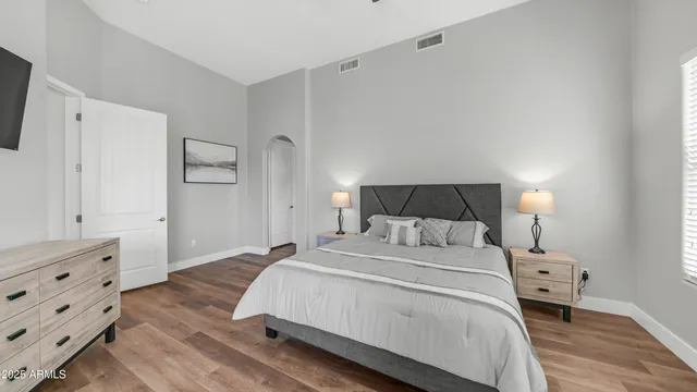 a bedroom with a bed and wooden floor