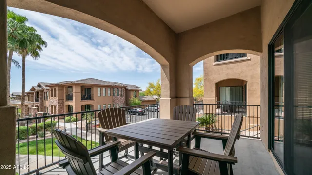 a view of a balcony with two chairs and a table
