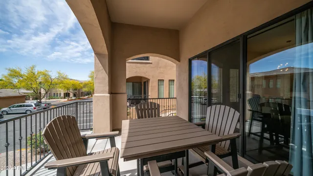 a view of a patio with table and chairs with wooden floor and fence