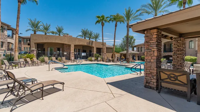 a view of a patio with dining table and chairs under an umbrella