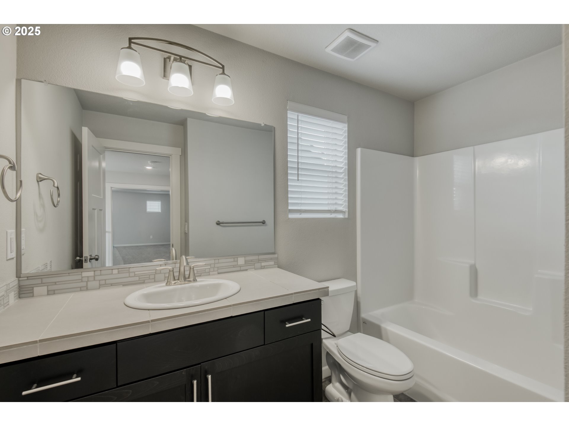 6443 Southeast 22nd Street Gresham, OR 97080 - Photo 19 of 27 a bathroom with a sink a toilet a shower and a mirror