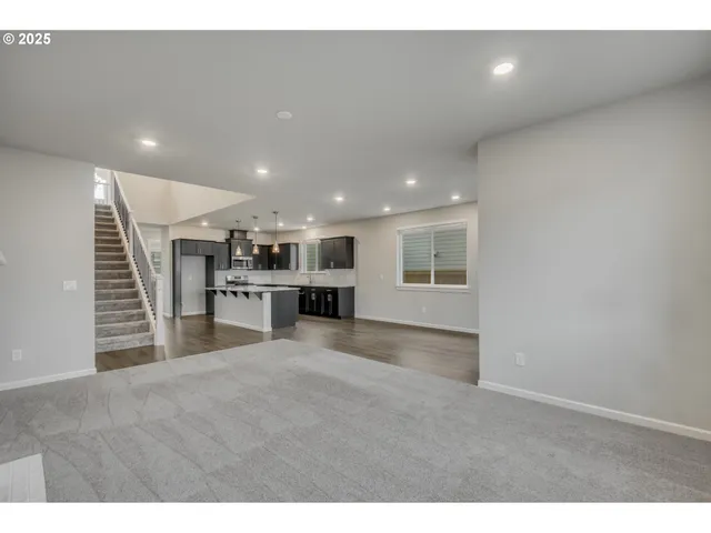 a view of kitchen with microwave and refrigerator