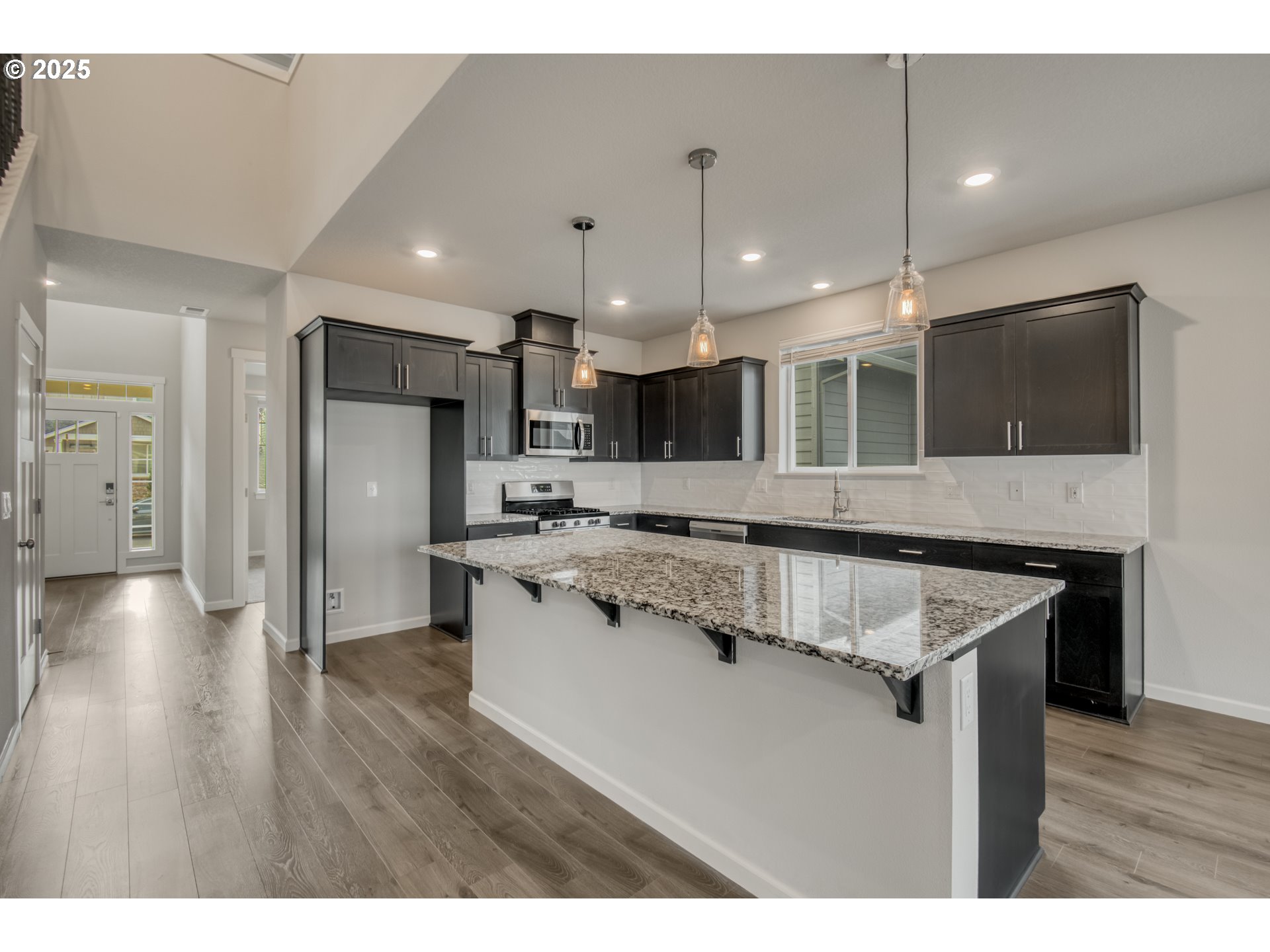6443 Southeast 22nd Street Gresham, OR 97080 - Photo 5 of 27 a kitchen with stainless steel appliances granite countertop a sink a stove and a wooden floors