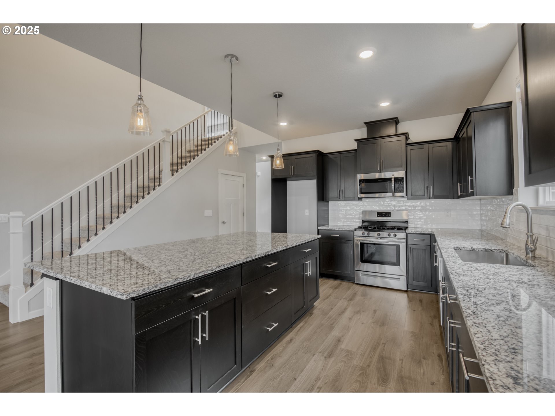 6443 Southeast 22nd Street Gresham, OR 97080 - Photo 6 of 27 a kitchen with stainless steel appliances kitchen island granite countertop a sink refrigerator and cabinets