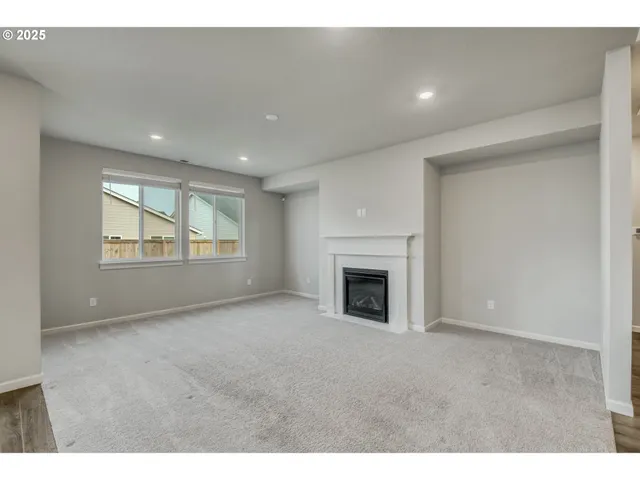 a view of empty room with a fireplace