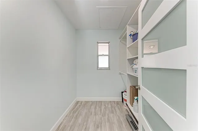 a view of hallway with stairs and wooden floor