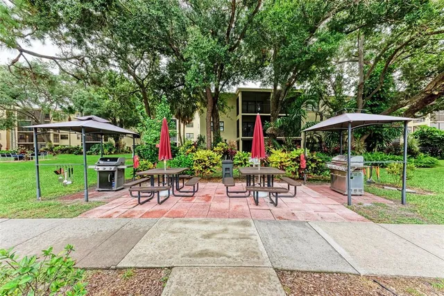a view of a chairs and table in patio with a small yard