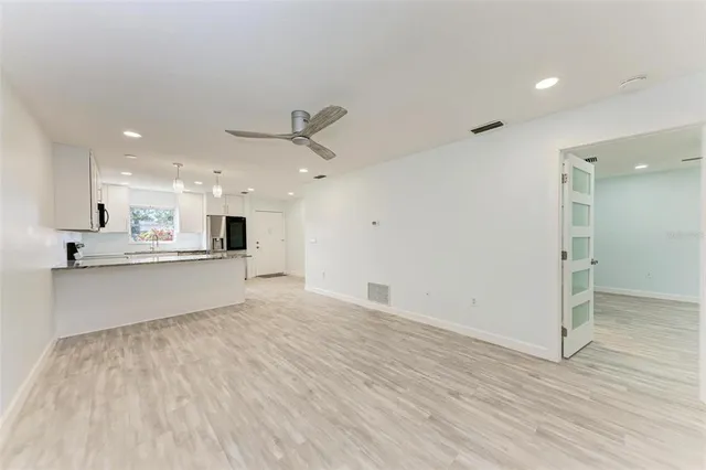 a view of kitchen with wooden floor and window