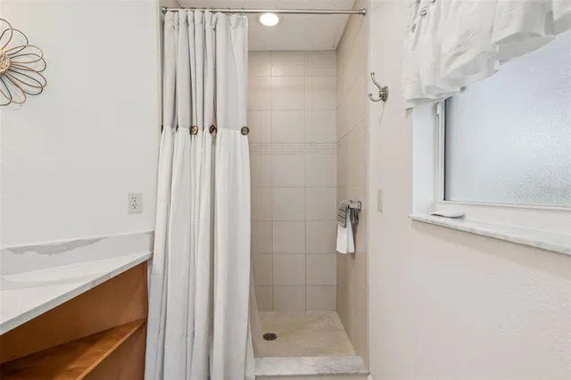 a view of a swimming pool with a porch and a small yard