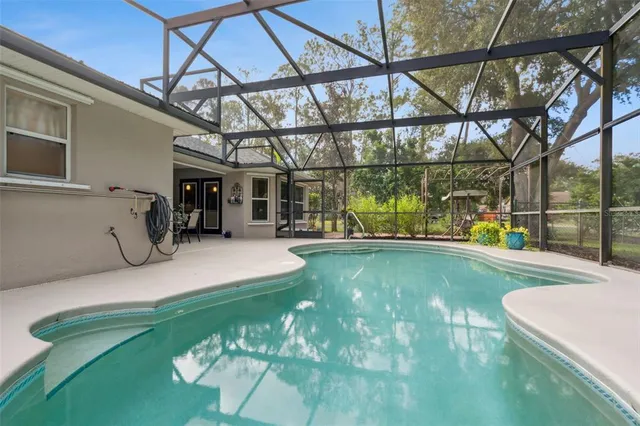 an aerial view of residential houses with outdoor space and trees