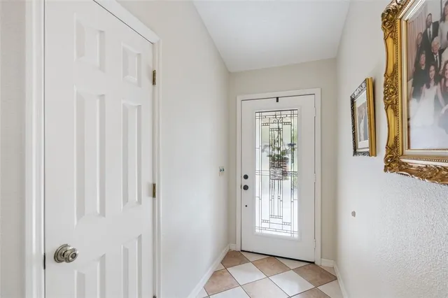 a large kitchen with stainless steel appliances granite countertop a sink a refrigerator and a wooden floor