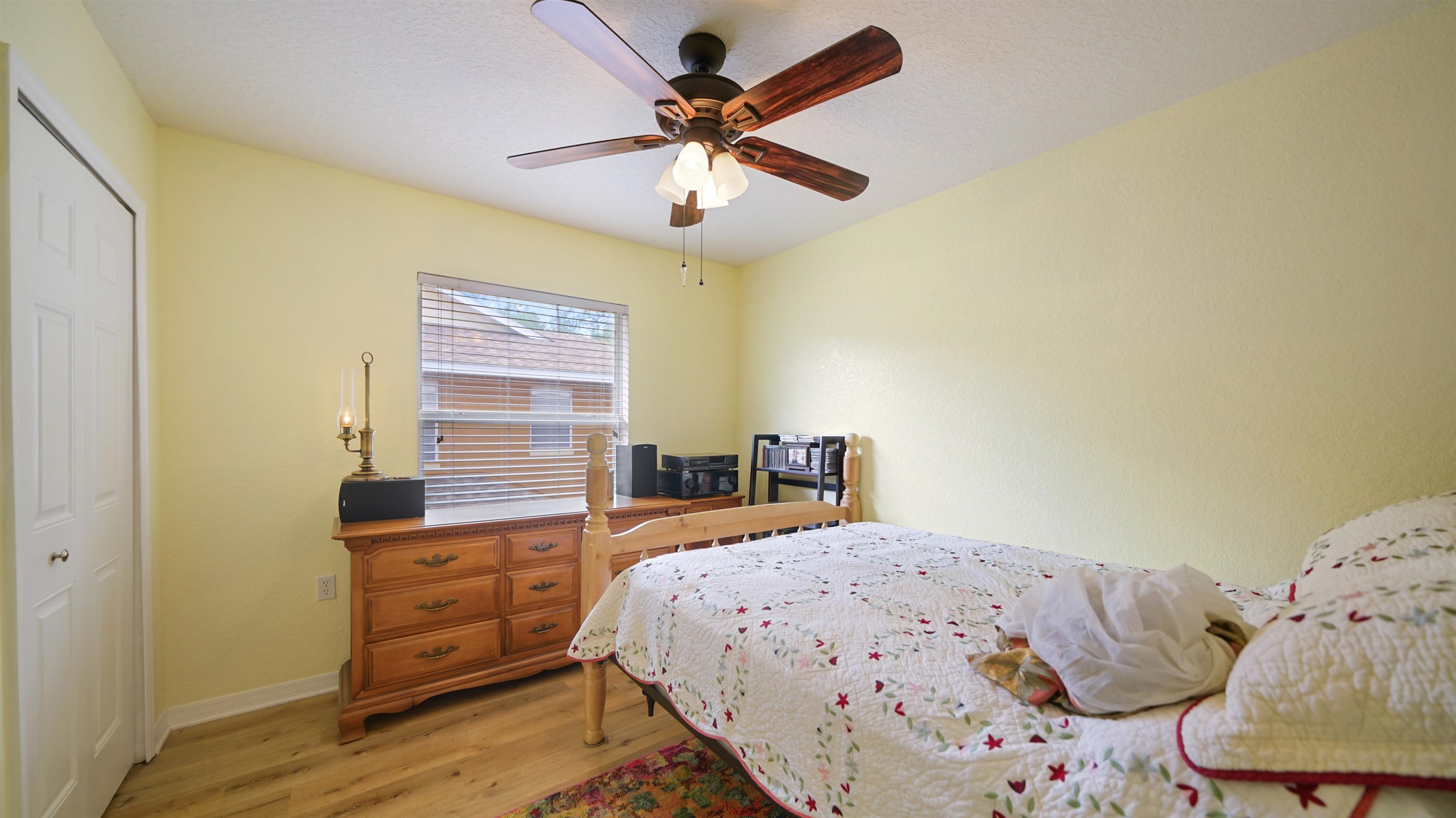 4600 East Moody Boulevard, Unit 8P Bunnell, FL 32110 - Photo 17 of 32 a bedroom with a bed and a chandelier
