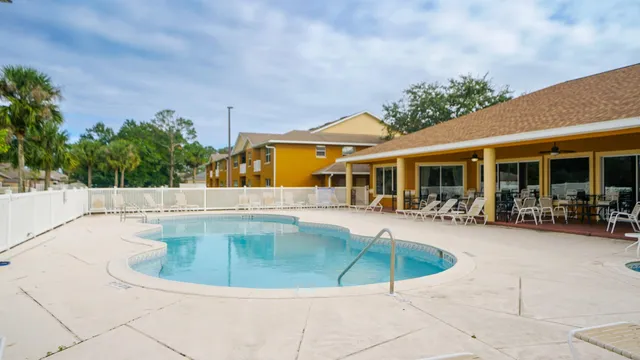 a view of a swimming pool with sitting area