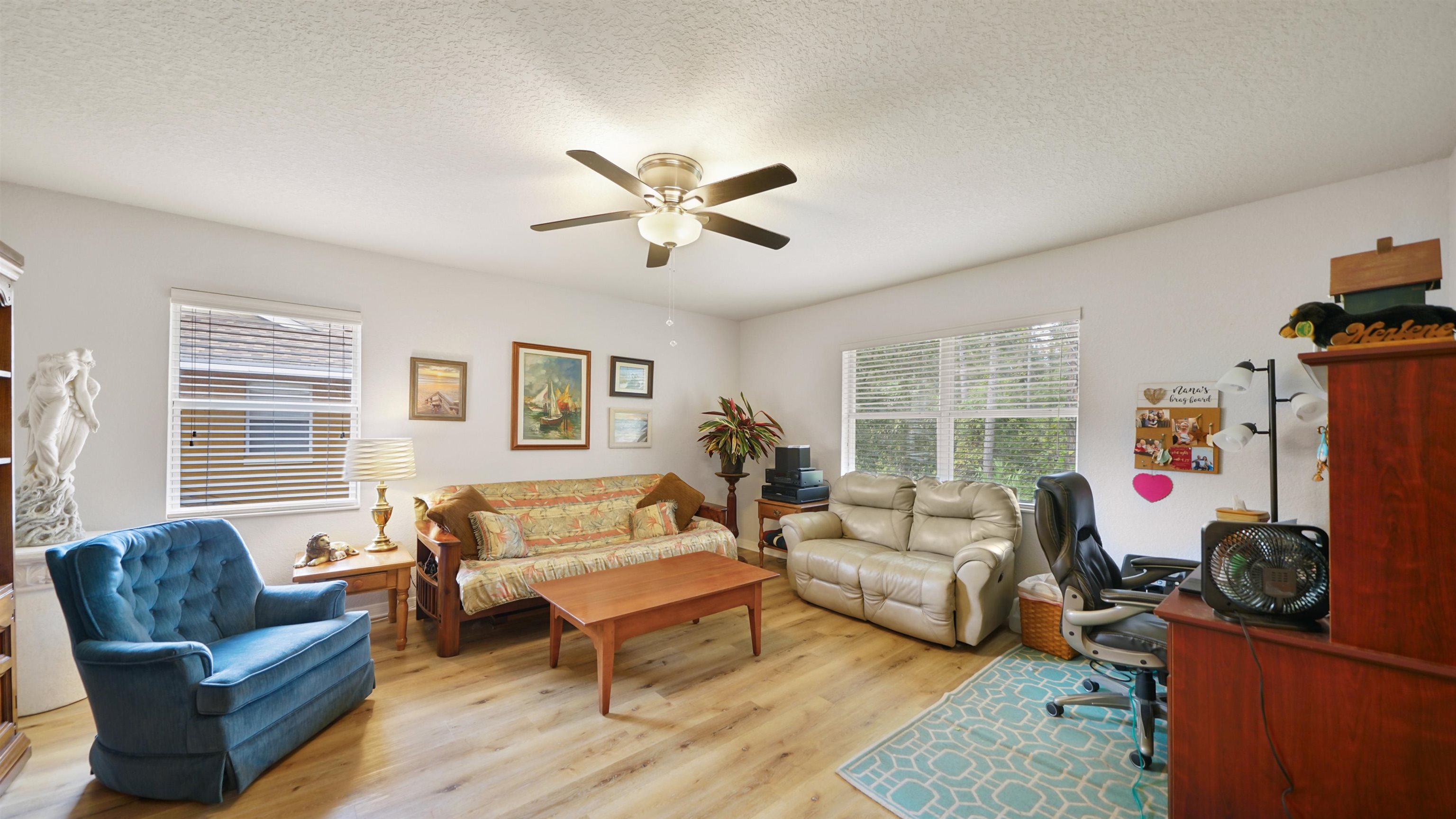 4600 East Moody Boulevard, Unit 8P Bunnell, FL 32110 - Photo 4 of 32 a living room with furniture a flat screen tv and a window