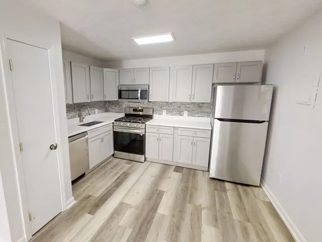 a view of room with window and wooden floor