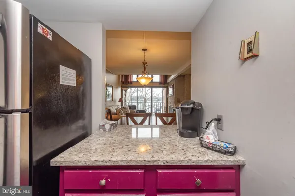 a kitchen with stainless steel appliances granite countertop a sink and a microwave