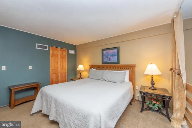 a bedroom with a bed and a dresser in it