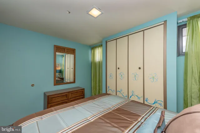 an aerial view of a house with green yard and large trees