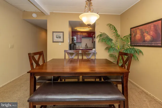 a view of a dining room with furniture a chandelier and wooden floor