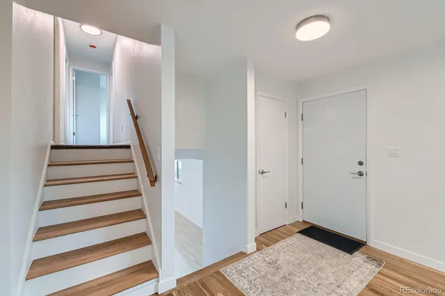 a view of entryway with stairs and wooden floor