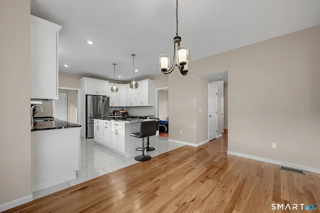 a view of a livingroom with furniture wooden floor and a window