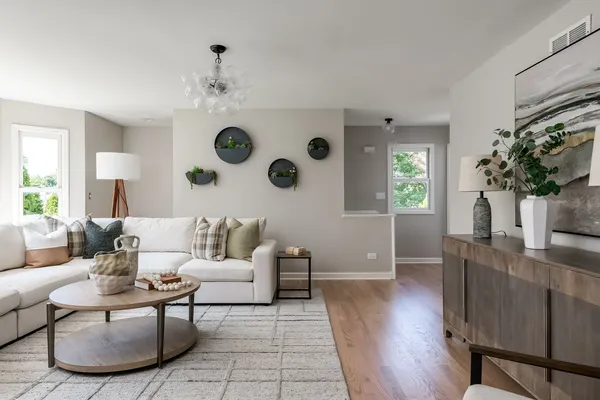 a living room with furniture and wooden floor