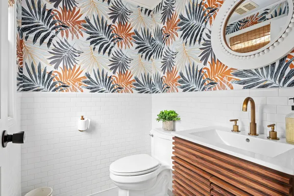 a bathroom with a sink a mirror and a toilet