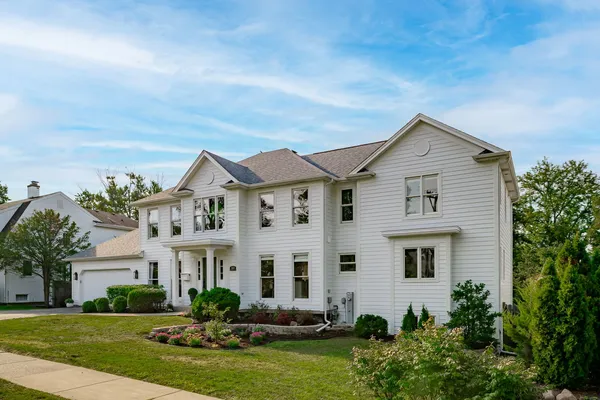 a front view of a house with a garden and plants