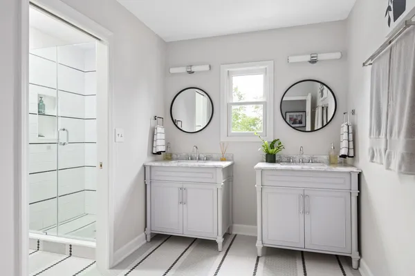 a bathroom with a double vanity sink and a mirror
