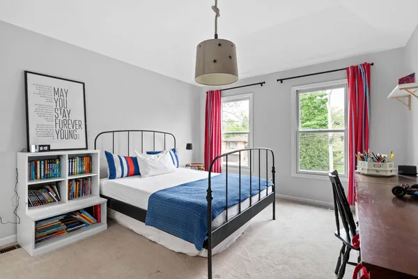 a bedroom with a bed and a book shelf