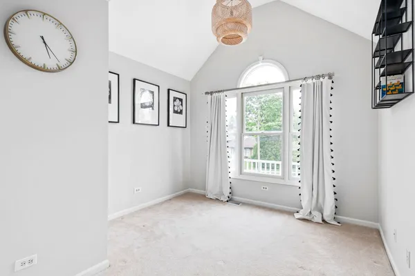 a view of a livingroom with furniture window and a chandelier