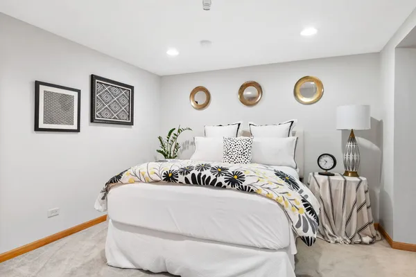 a bedroom with a bed and a chair