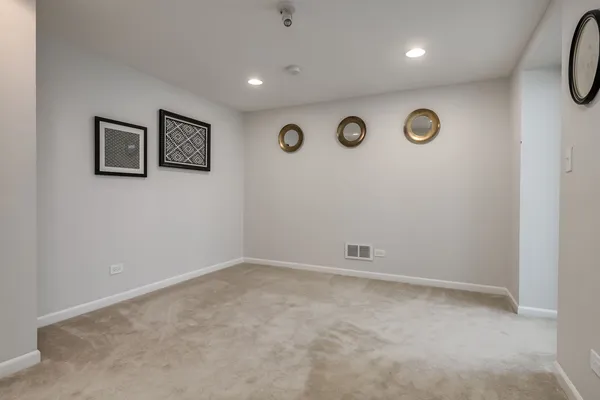 an empty room with a wall painting and a window