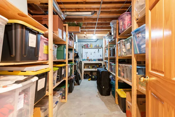 a view of walk in closet with clothes and shoes
