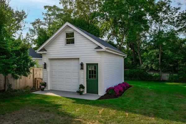 a view of a house with a yard and potted plants