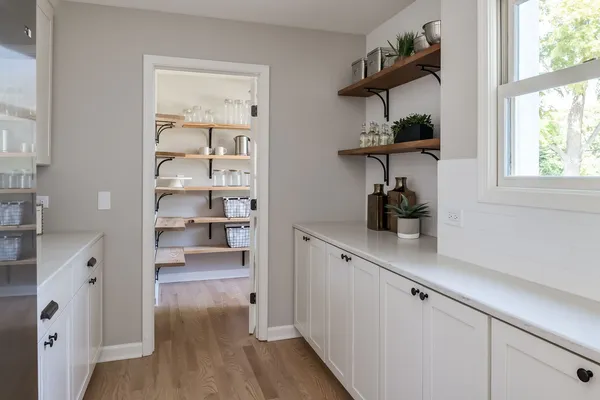 a kitchen with wooden floor and a window
