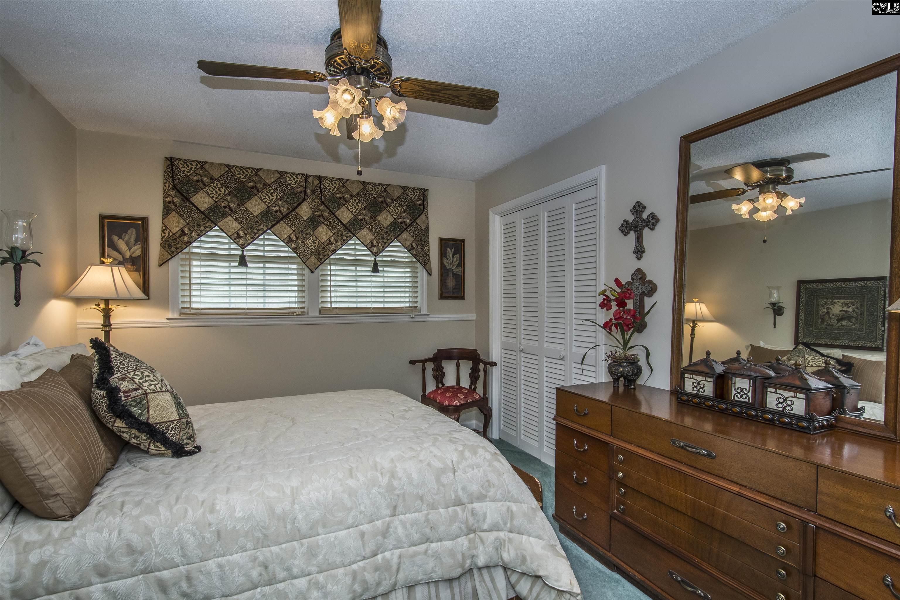 2309 Cunningham Road Columbia, SC 29210 - Photo 40 of 41 a bedroom with a bed and a chandelier